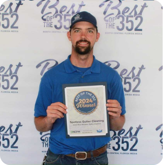 Kenion Bryant, Owner of Spotless Gutter Cleaning accepting the Best of the 352 award